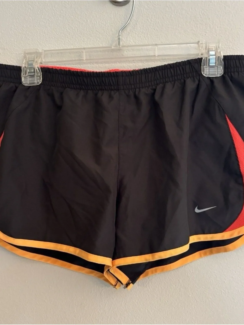 Nike Women’s Black Athletic Shorts with Orange Trim and Red Panels